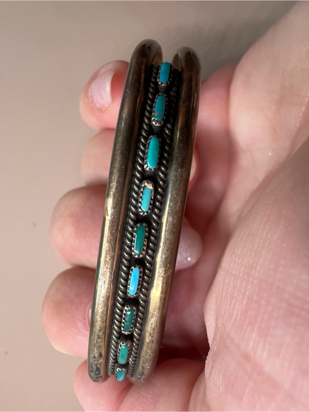 Zuni sterling silver cuff bracelet with a single row of needlepoint turquoise